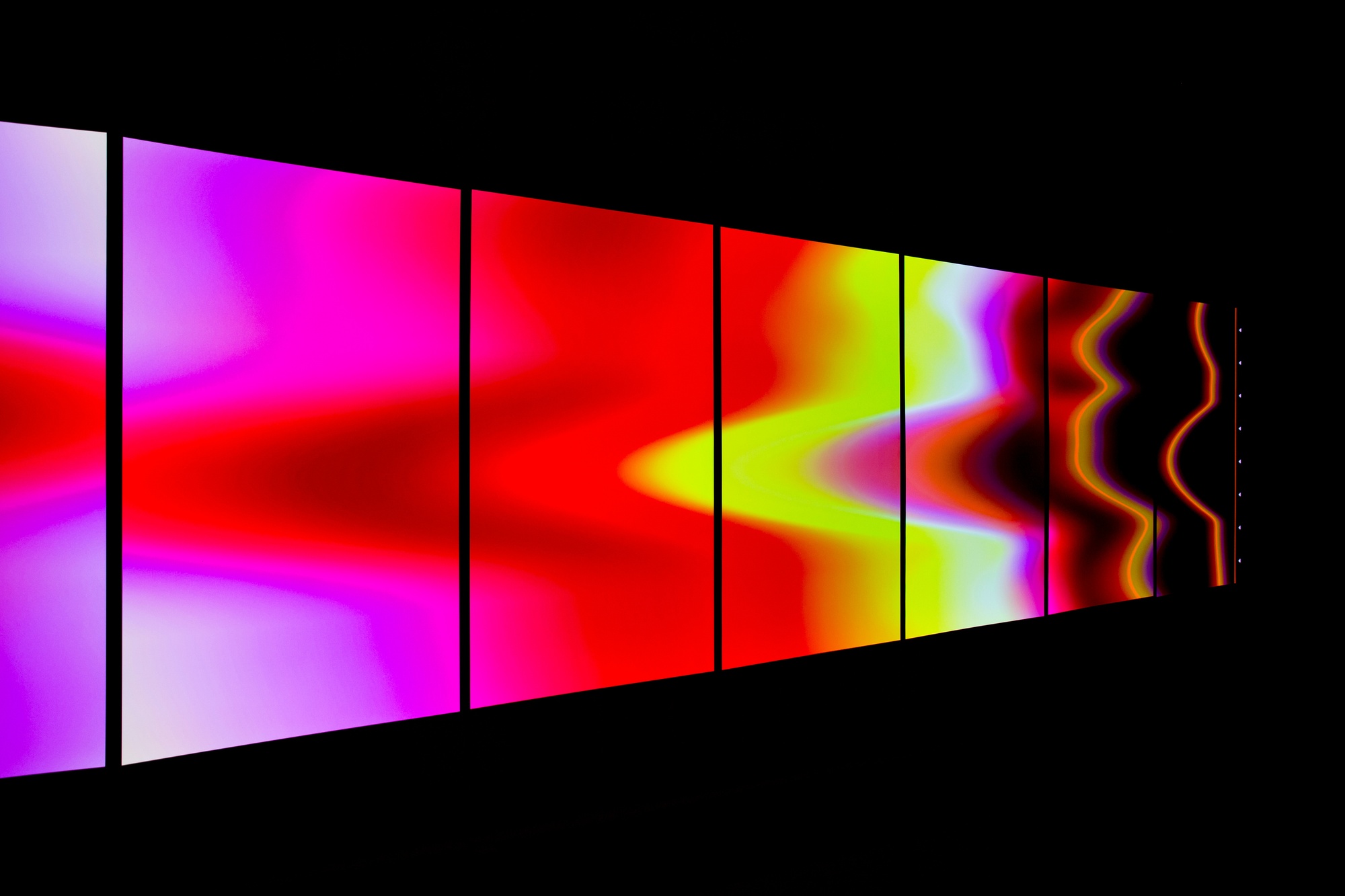 Side view of angled digital surface with colored striations running on it