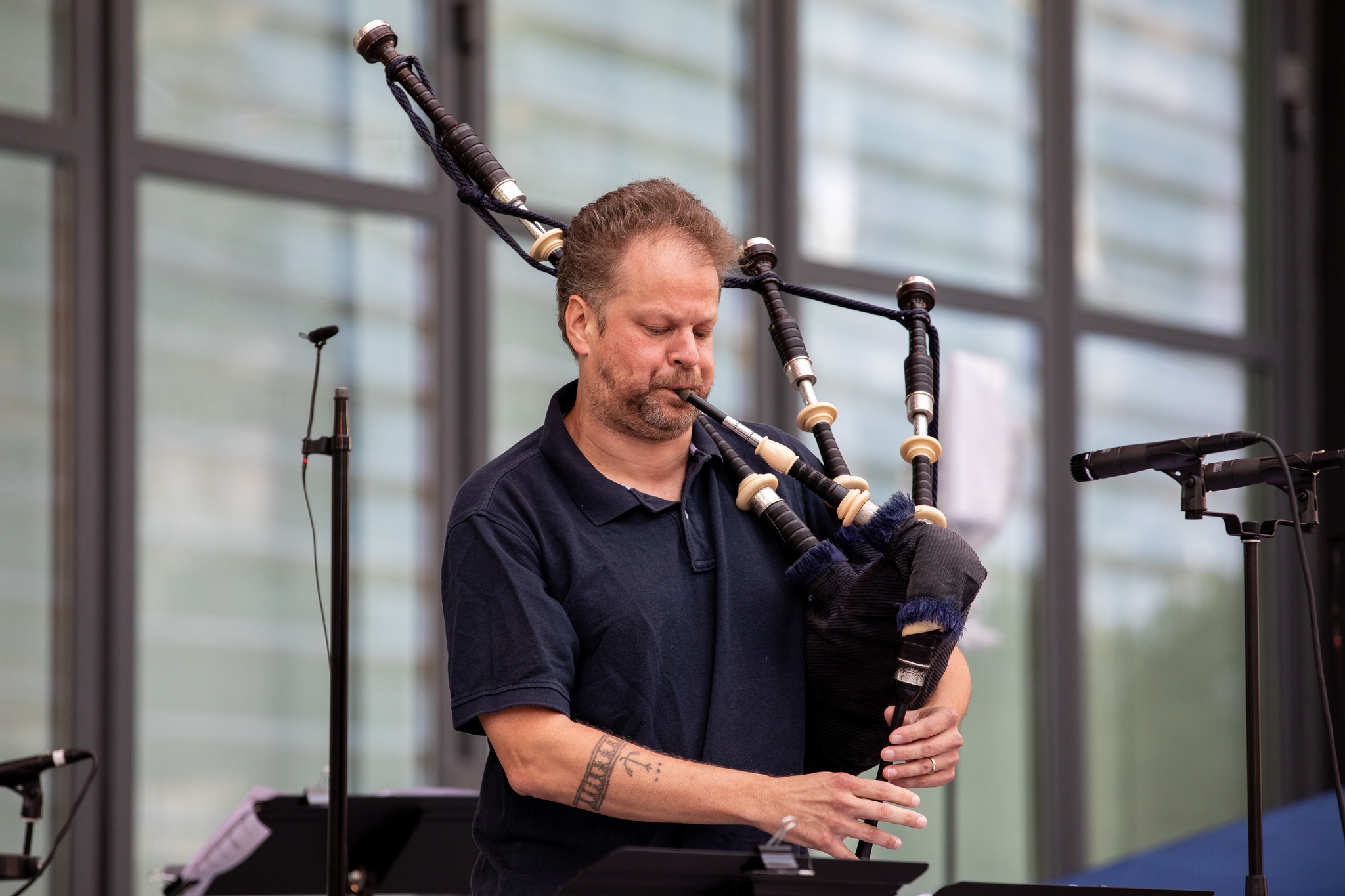 Man playing live instruments on a stage.