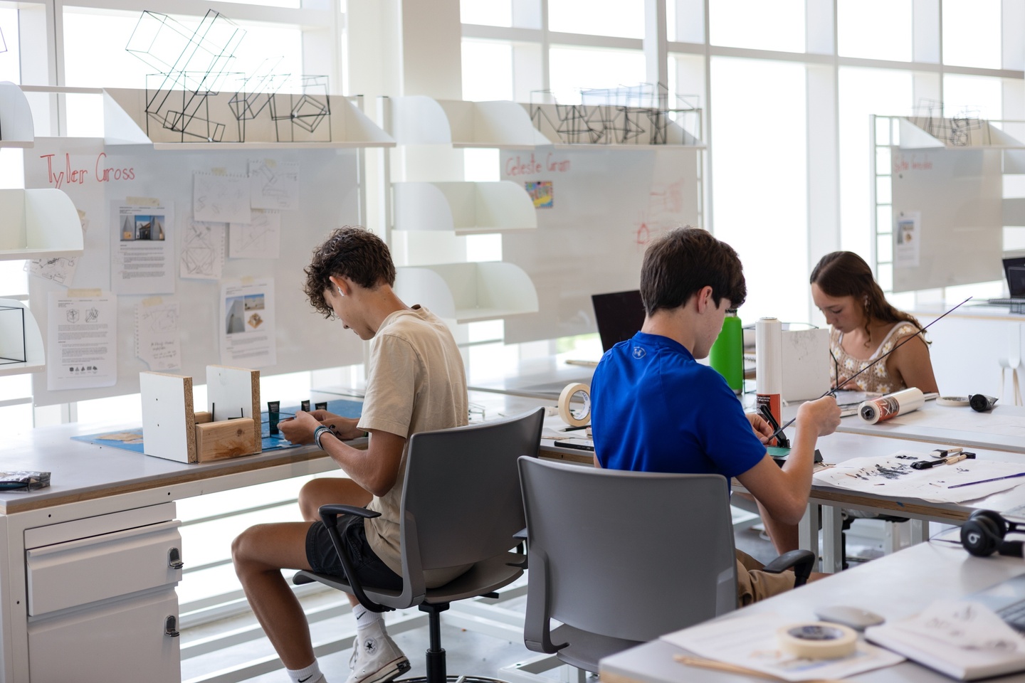 Students sitting at a table working on architecture projects