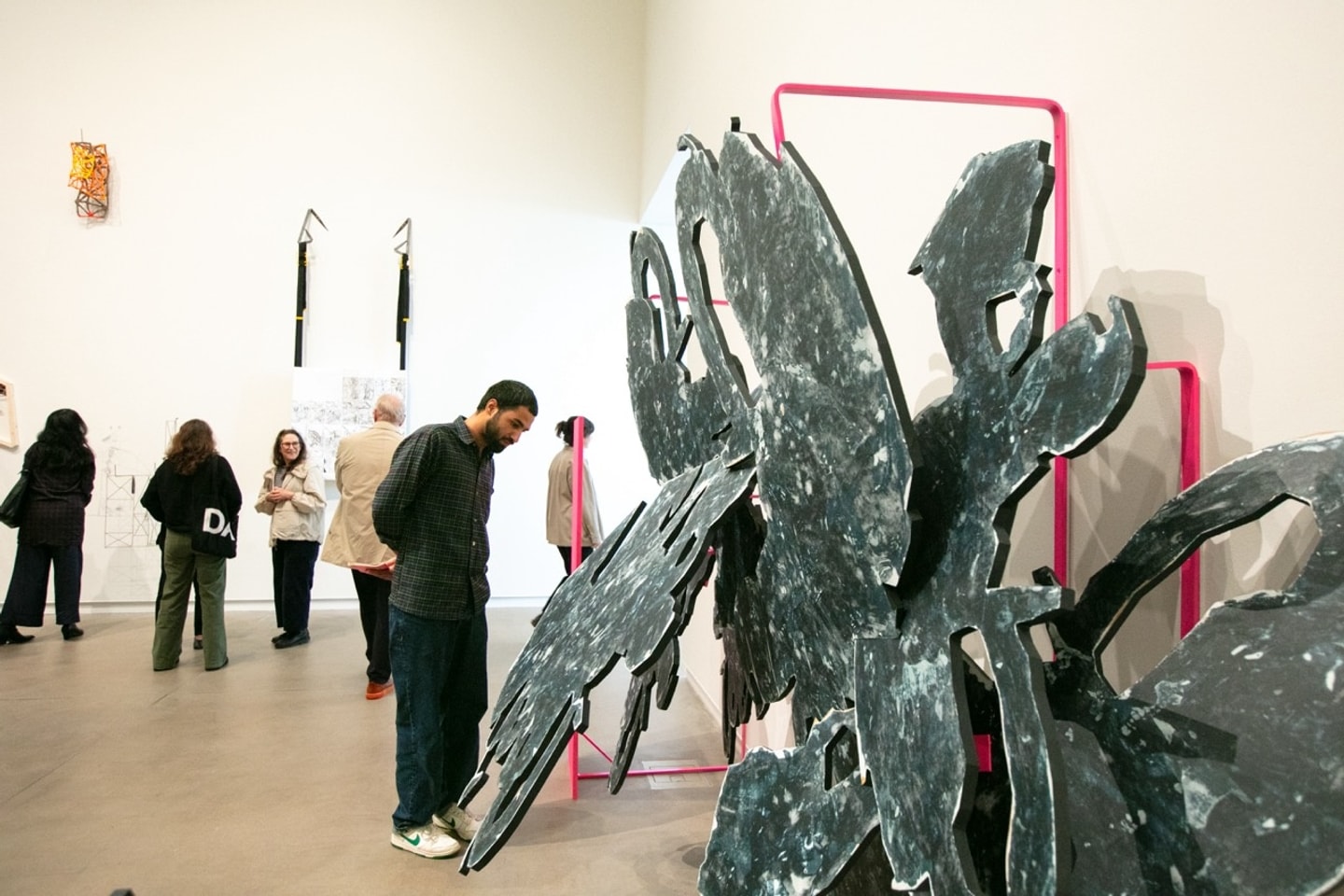 large abstract sculpture in grays and neon pink