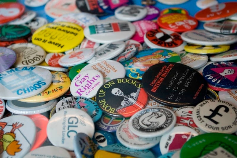 A colorful collection of button badges with various texts on them
