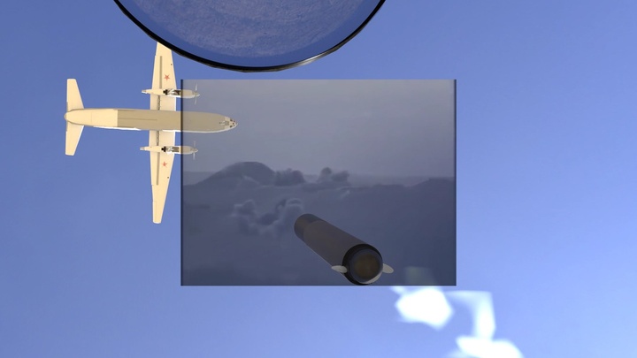 Video still of a plane flying east against a blue sky, about to cross a screened rectangular box showing a cloudy sky and a missile.
