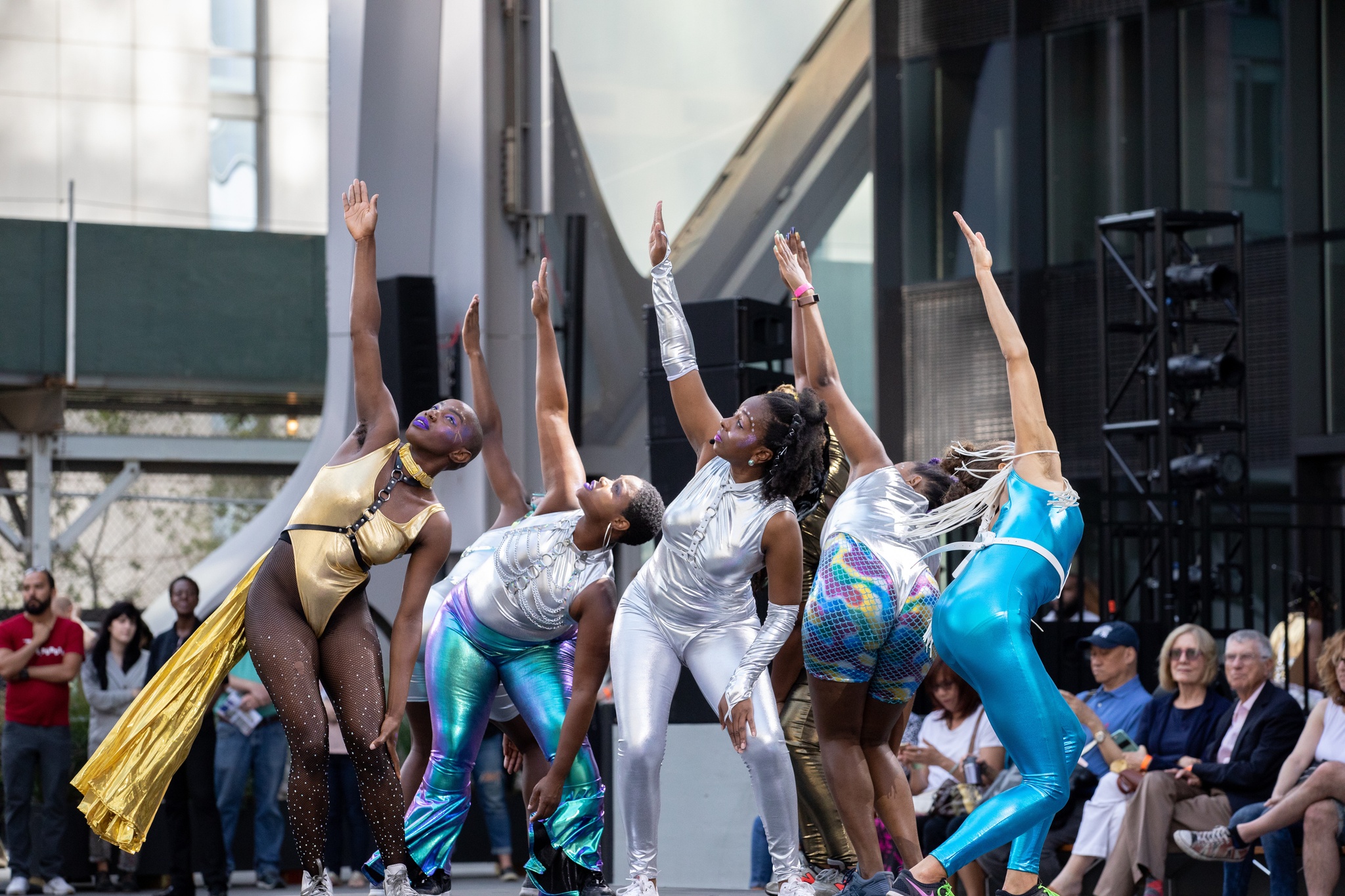 Dancers in motion on an outdoor stage.